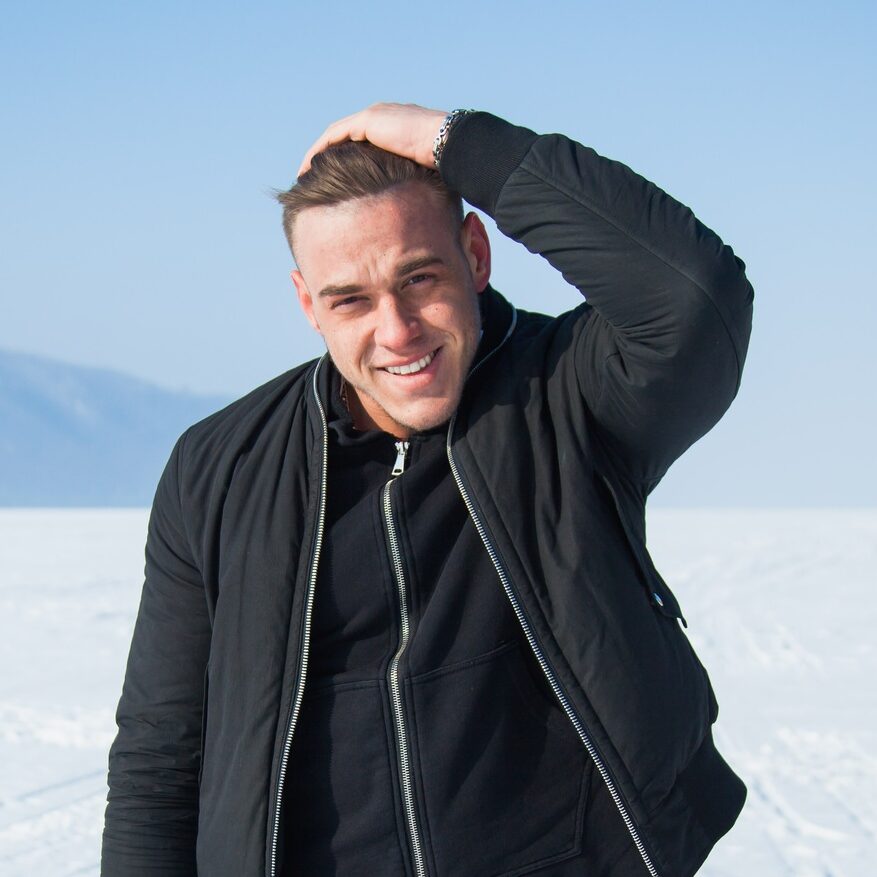 Handsome guy smiling outside in winter.