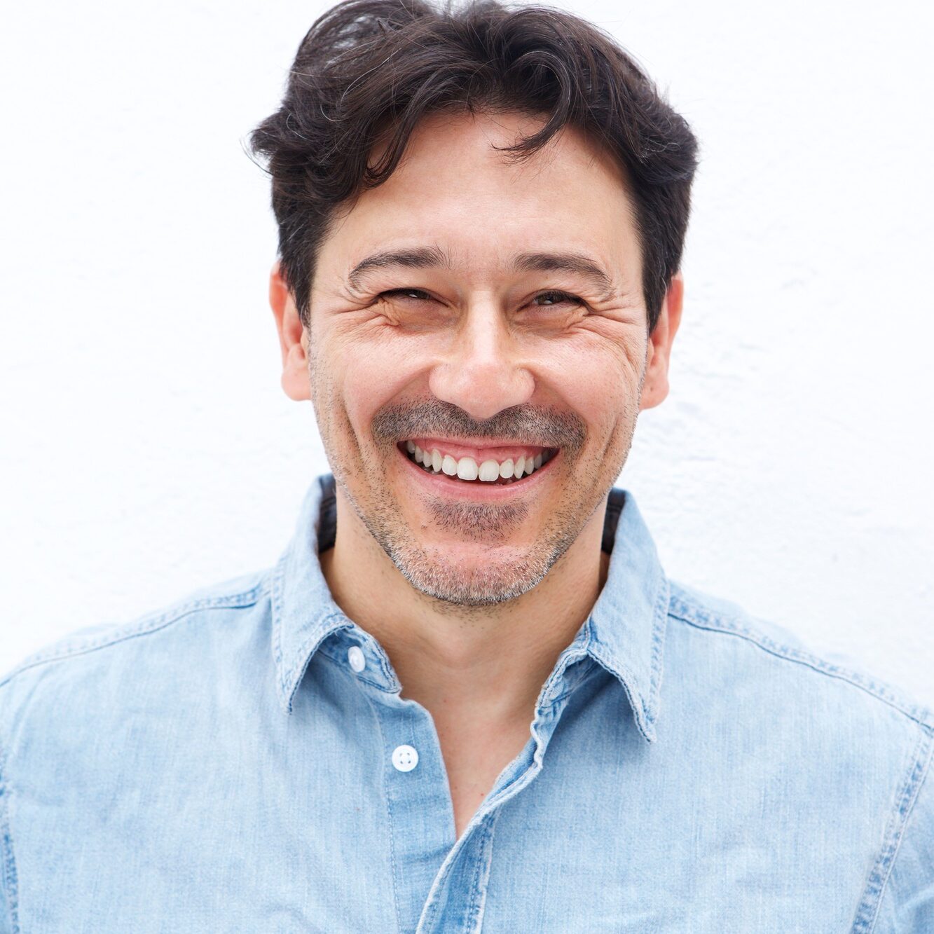 handsome mature guy smiling against white background