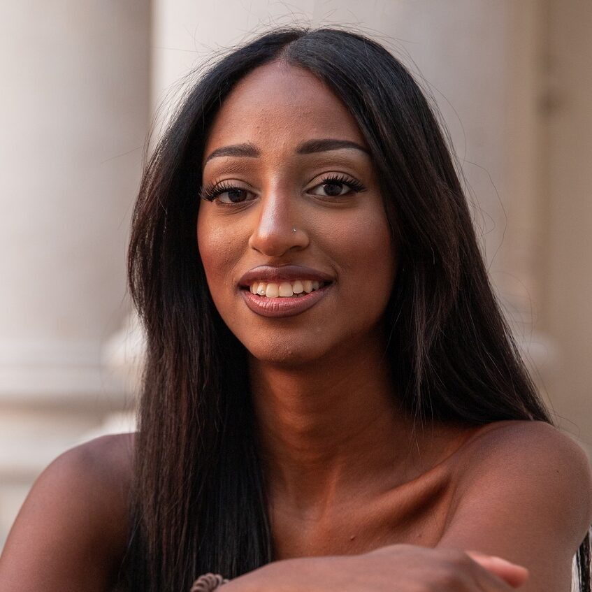 Portrait of an eastern african girl, smiling young lady outdoor in the city center.