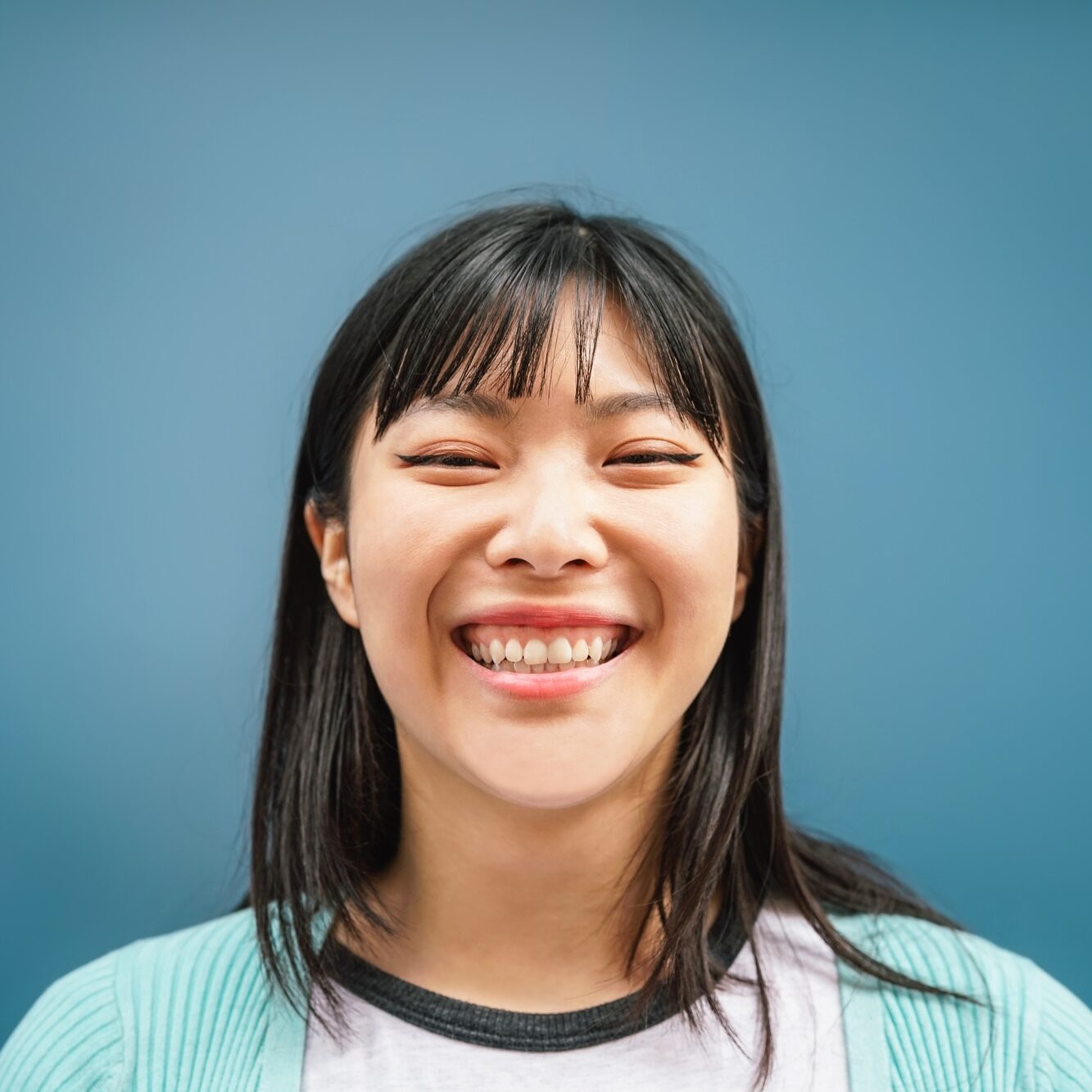Portrait of young Asian girl smiling at camera